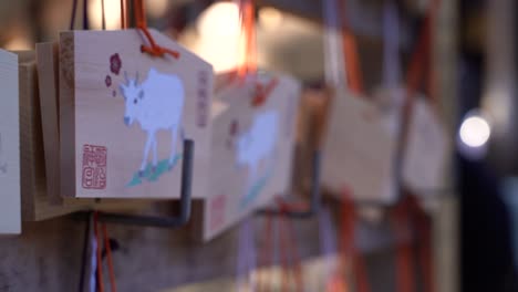 slow tracking typical wooden wishing cards at japanese shrine low depth of field