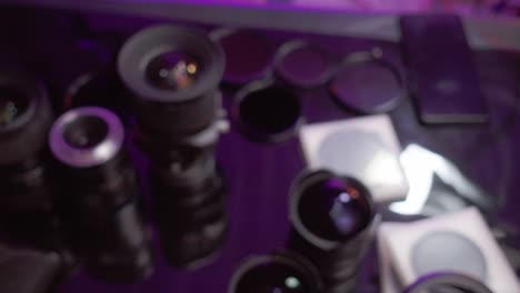 a collection of camera lenses and filters arranged on a surface for cleaning and inspection