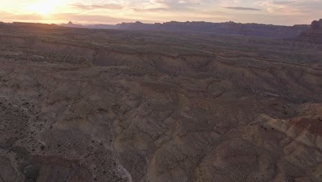 aerial view of the sun setting over a mesa desert landscape