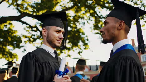 graduates celebrating on campus with diplomas