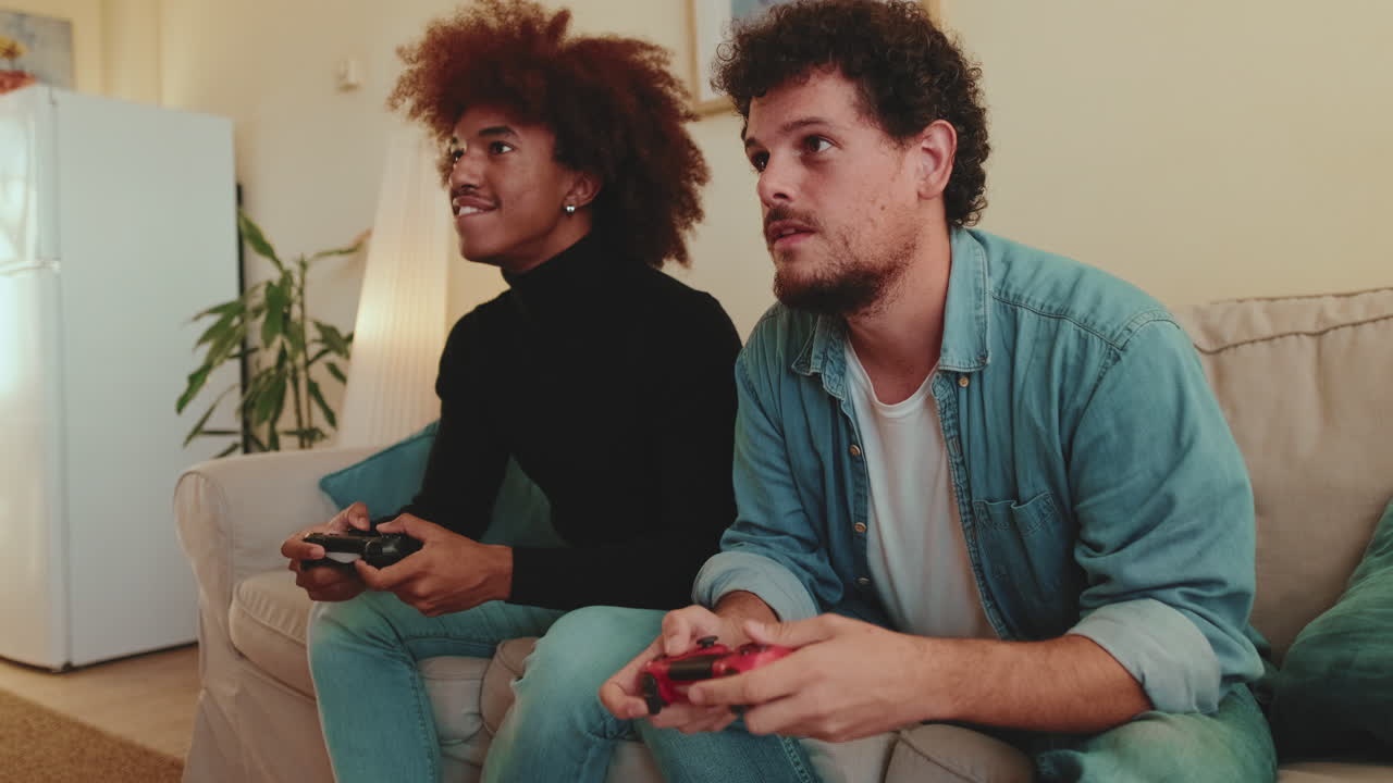 Two friends playing video games at home