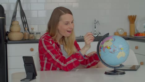 dreamy adult woman with eyes closed choosing travel destination on world globe