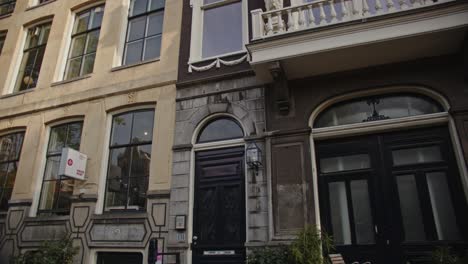 tilt up of beautiful canal-side house in amsterdam city center on a sunny day