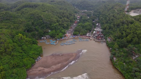 Aerial-view-of-the-bay-is-surrounded-by-hills-and-forest-which-is-used-as-a-harbor-for-fishing-boats