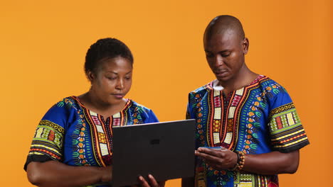 african american woman buying clothes online on laptop