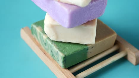 artisan handmade soap bars on wooden soap dish