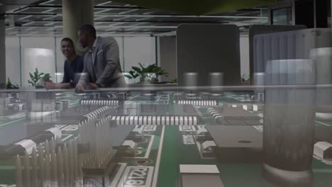 Animation-of-office-building-over-business-people-talking-in-modern-office