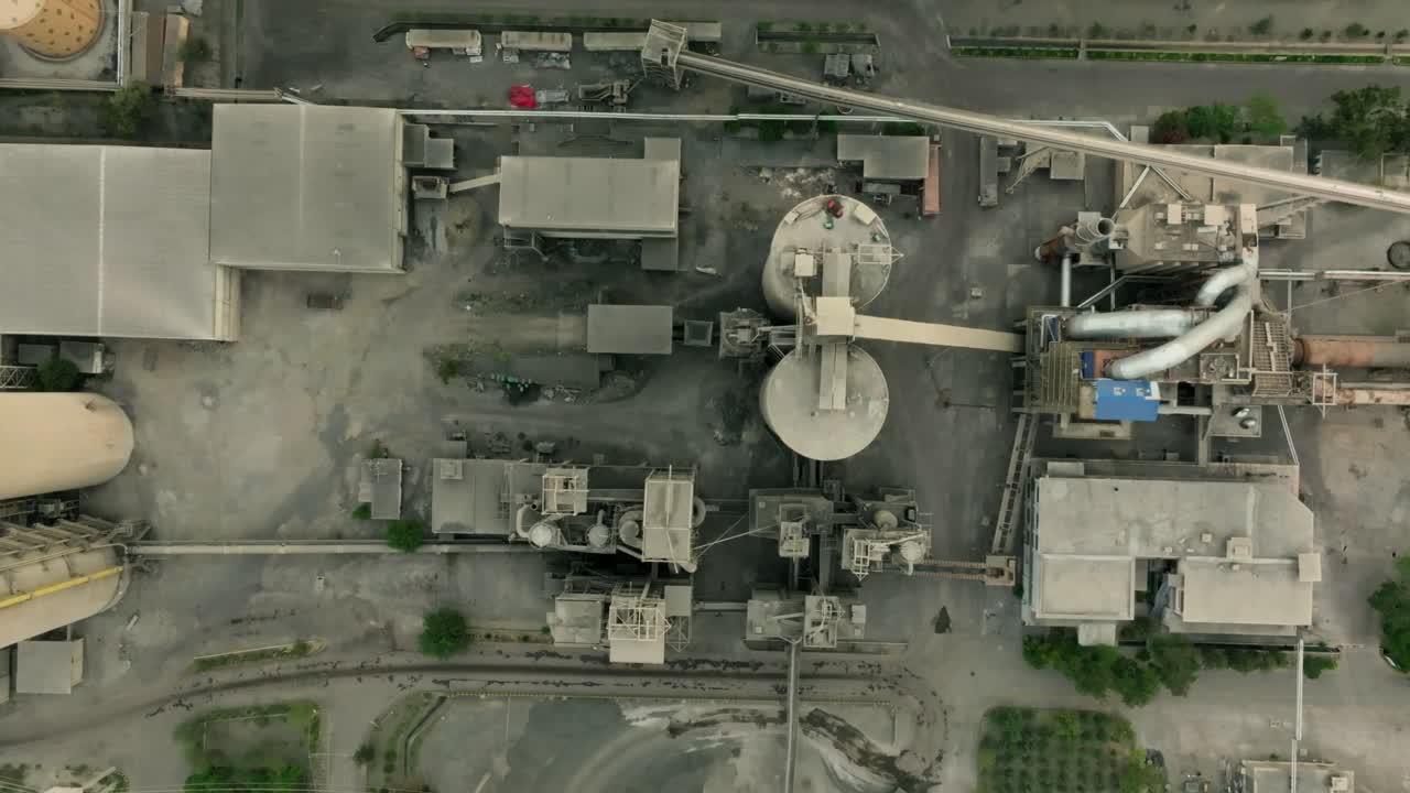 Industrial cement factory complex from an aerial perspective within Karachi's industrial area. Birds Eye View, Rising Shot