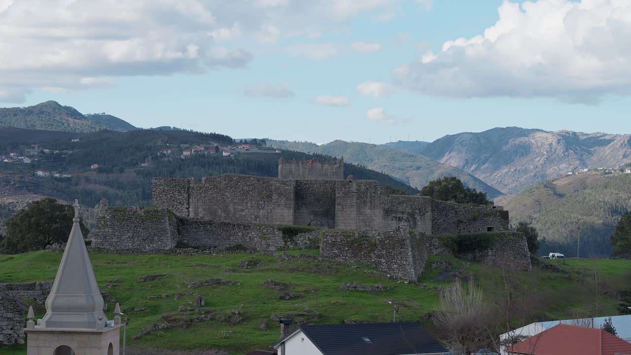 Stone walls of Lindoso castle with scenic mountain range in Alto Minho Portugal