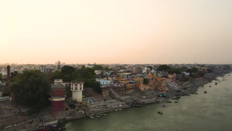 drone shot of banaras and the ganga river, highlighting the historical ghats and temples along the banks.