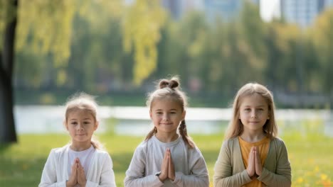 three girls meditating in a park