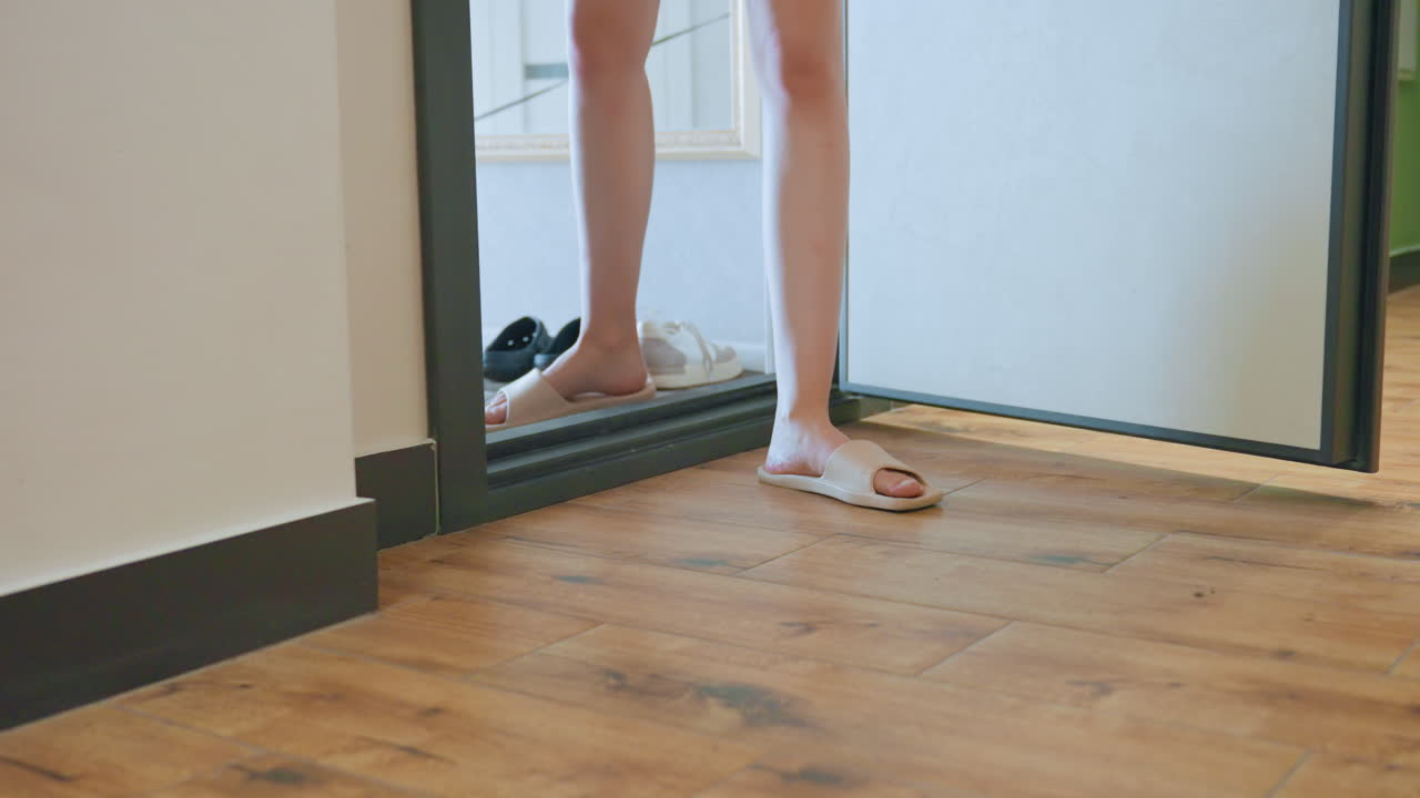 Woman Feet Doorway Leashed Dog Preparing To Exit Apartment, Threshold Shot With Shoes Arranged Inside, Owner Holding Leash While Puppy Sniffs Floor, Urban Morning Energy And Routine Departure Captured