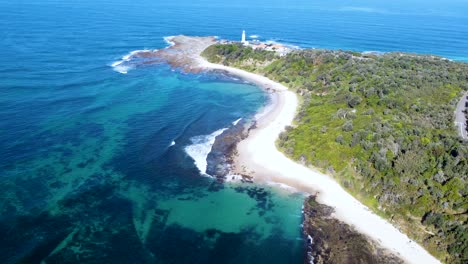 Drone-aerial-landscape-shot-of-lighthouse-crystal-clear-reef-and-ocean-beach-Norah-Head-Central-Coast-tourism-NSW-Australia-4K