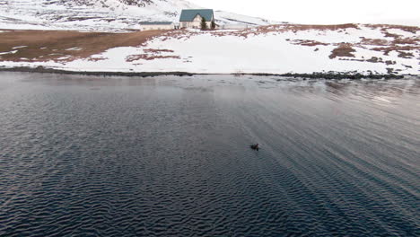 lonely duck floating on wavy water in fjord