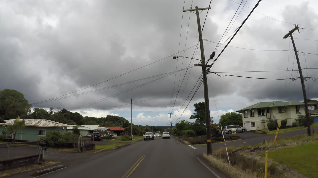 Cars driving in residential neighborhood in Hawaii, street view.