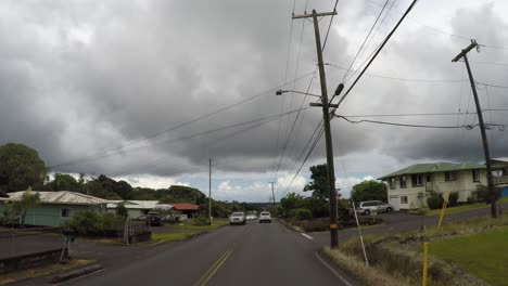 cars driving in residential neighborhood in hawaii, street view.