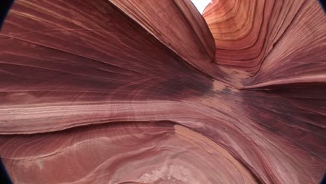 panright of swirled sandstone canyon walls in a desert