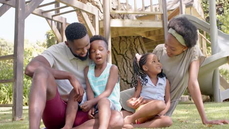 portrait of happy african american family in garden, in slow motion