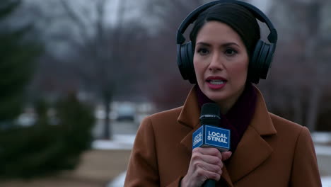 female reporter broadcasting with microphone and headphones