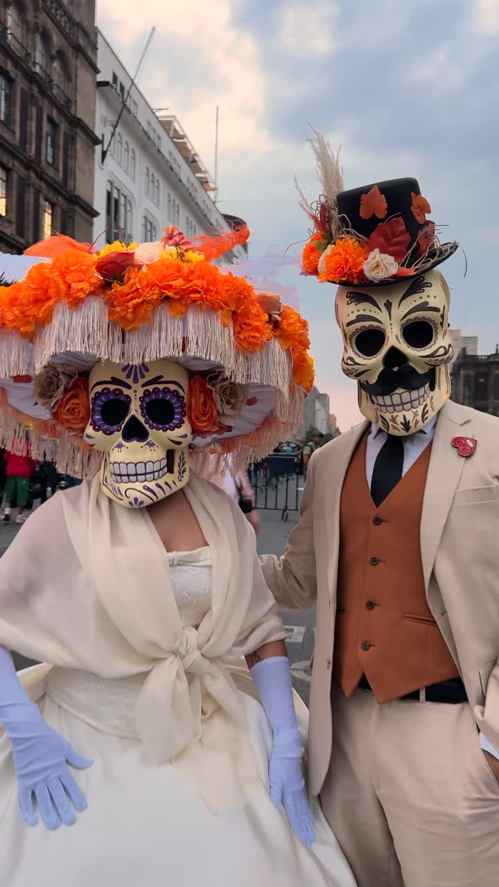 Catrin and Catrina couple in traditional attire celebrating Day of the Dead in downtown Mexico City