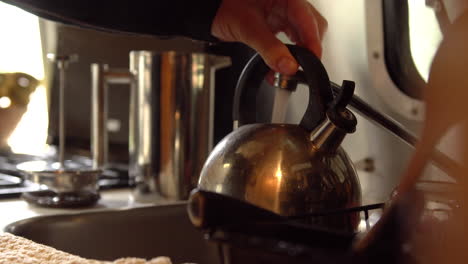 Filling-a-tea-pot-with-water-from-inside-a-Airstream