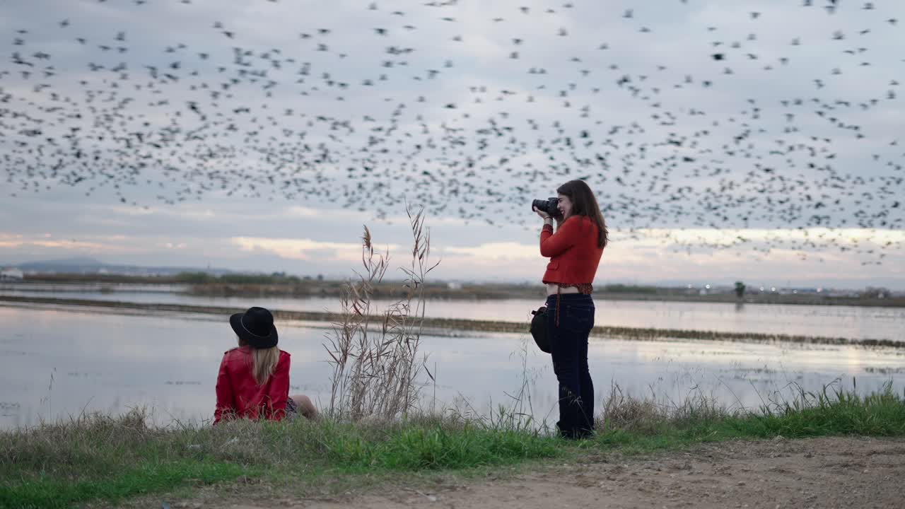 Women Photographing a Flock of Birds