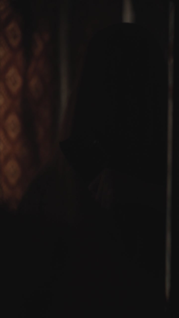 Chilling Halloween cinematic shot of a haunted woman standing in front of a mirror with flickering lights creating an eerie mood. Ideal for Halloween visuals,