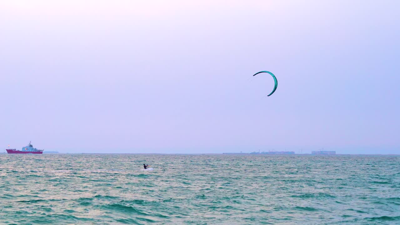 un kitesurf solitario disfruta de las amplias aguas abiertas de kite beach en dubai