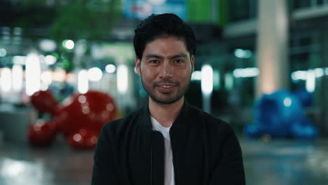man smiling in a modern building at night