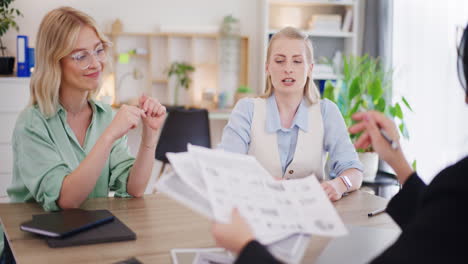three women discuss sales results during business meeting