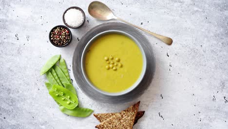 Green-pea-cream-soup-in-grey-bowl