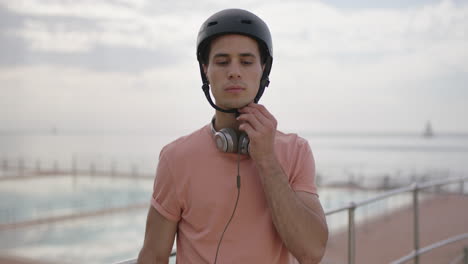 portrait-of-young-attractive-man-wearing-helmet-removes-sunglasses-staring-confident