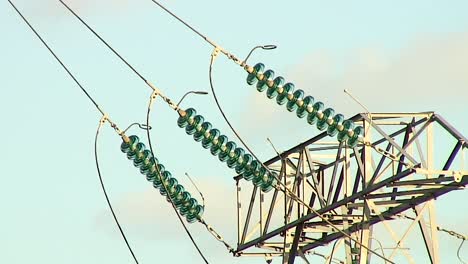 An-electricity-pylon-supporting-power-cables-carrying-power-across-a-rural-area-in-the-county-of-Rutland-in-England