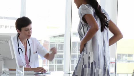 female doctor and her patient talking after an exam