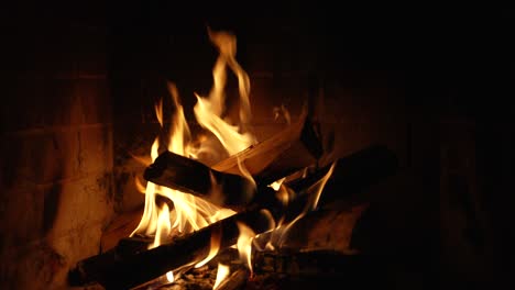 burning fire in the fireplace. wood and embers in the fireplace detailed fire background