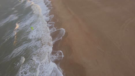 Fast-orbiting-drone-shot-around-the-kite-of-a-kitesurfer-during-sunset