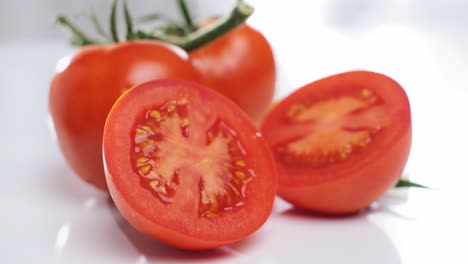 healthy food, fresh tomatoes displayed on white background, tracking out shot