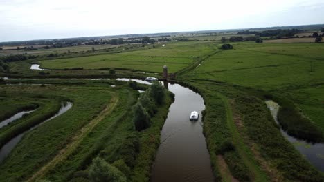 Luftdrohne-4K-Aufnahmen-Eines-Bootes,-Das-Durch-Die-Biegungen-Des-Flusses-Yare,-Norfolk-Broads,-Norfolk-Navigiert