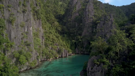 Scenic-Tropical-Lagoon-Surrounded-By-Cliffs---aerial-drone-shot