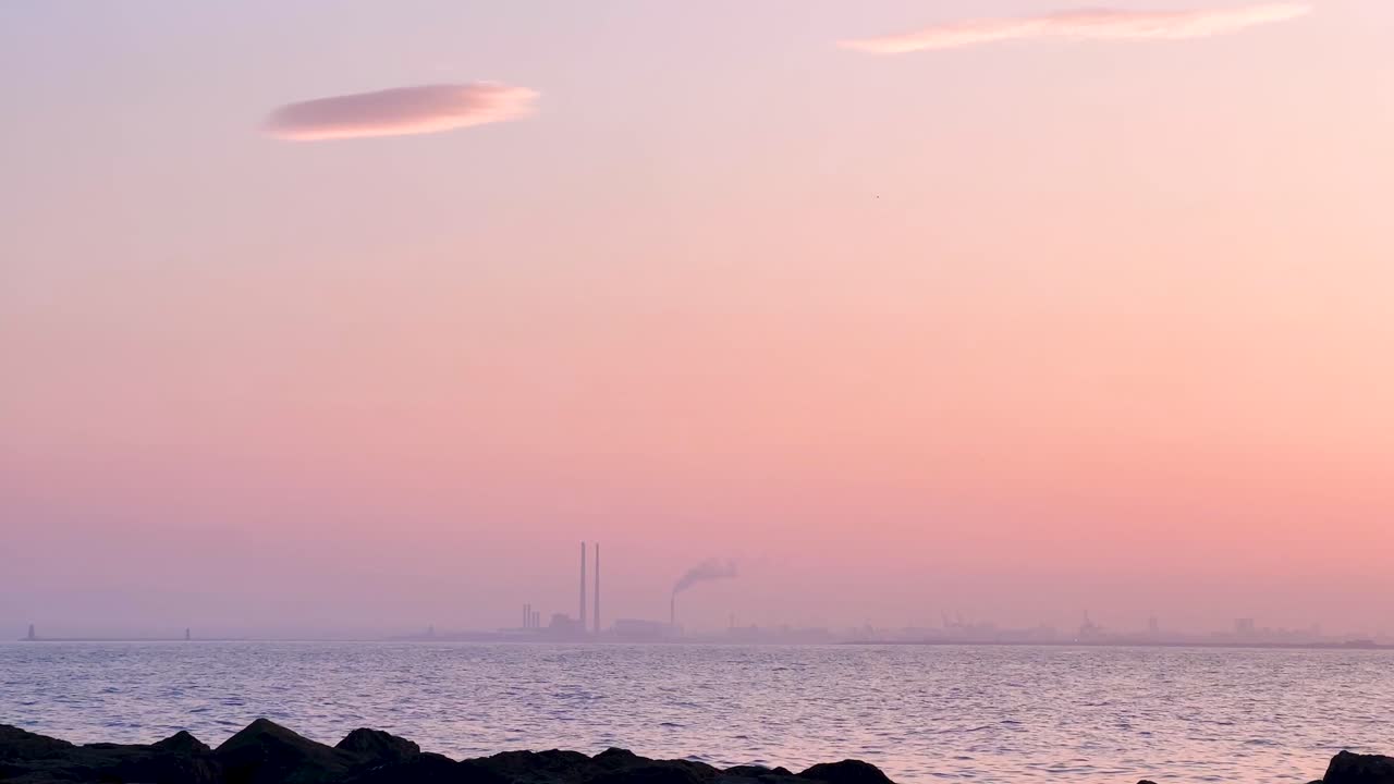 Poolbeg Towers at Sunset with Light Fog, Pink Sky, Calm Sea and Fluffy Clouds