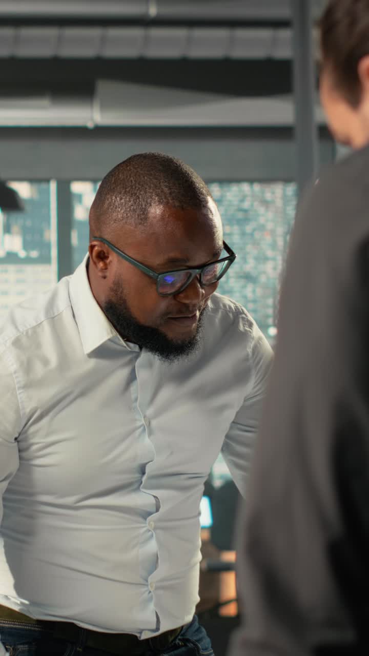 Vertical Video Employees and coworkers discussing business intel and performance metrics