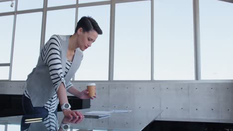 beautiful caucasian businesswoman looking at document in modern office 4k