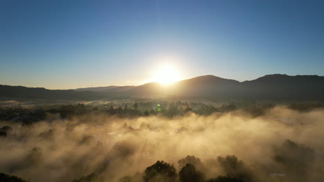 sun rising over the mountains with dense fog, stunning aerial view in the caribbean