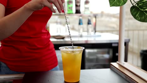 woman preparing an orange juice cocktail