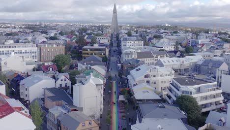 rainbow road leading towards famous church hallgrimskirkja in reykjavik, aerial