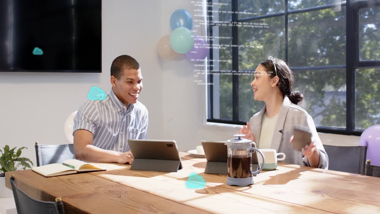 Man tapping tablet, woman gesturing at table, cloud code growing between tablets for tech review