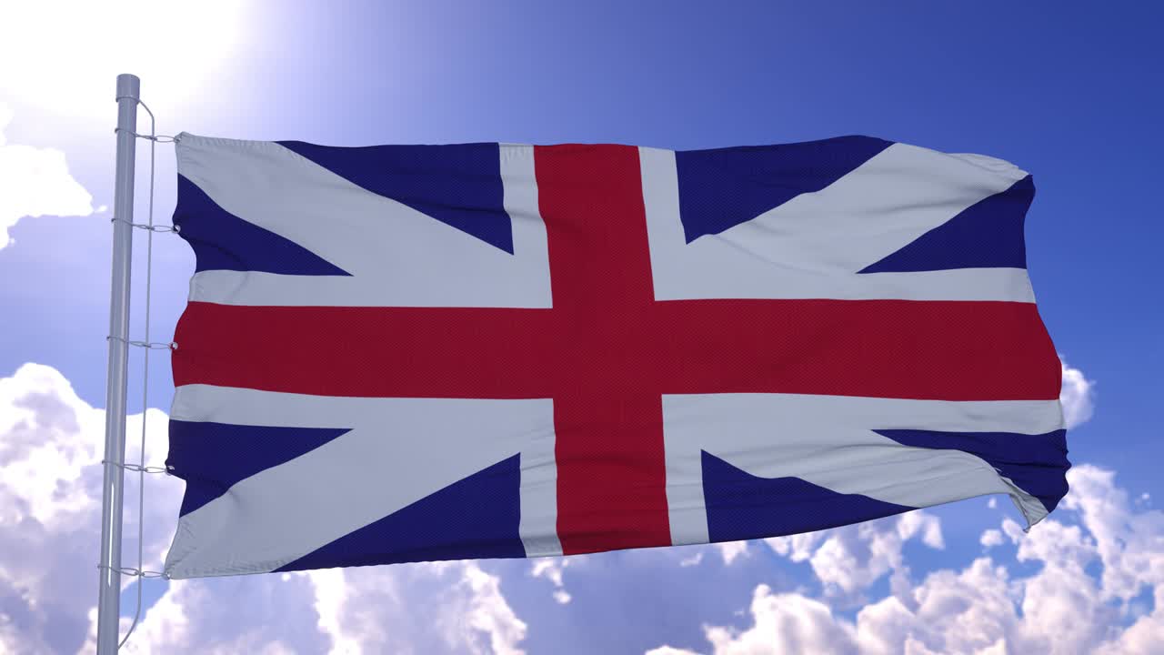 United Kingdom flag waving in wind against blue sky