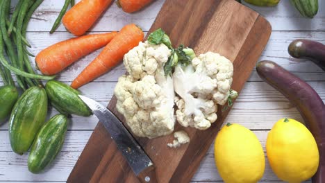 assortment of fresh vegetables on a wooden cutting board