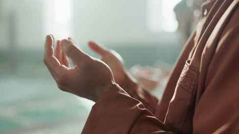 Muslim-man,-praying-and-mosque-with-hands