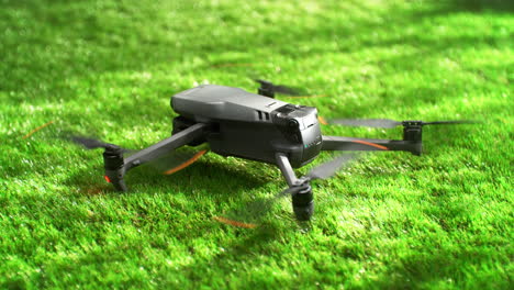 remotely controlled uncrewed quadcopter takes off from green grass, slow motion
